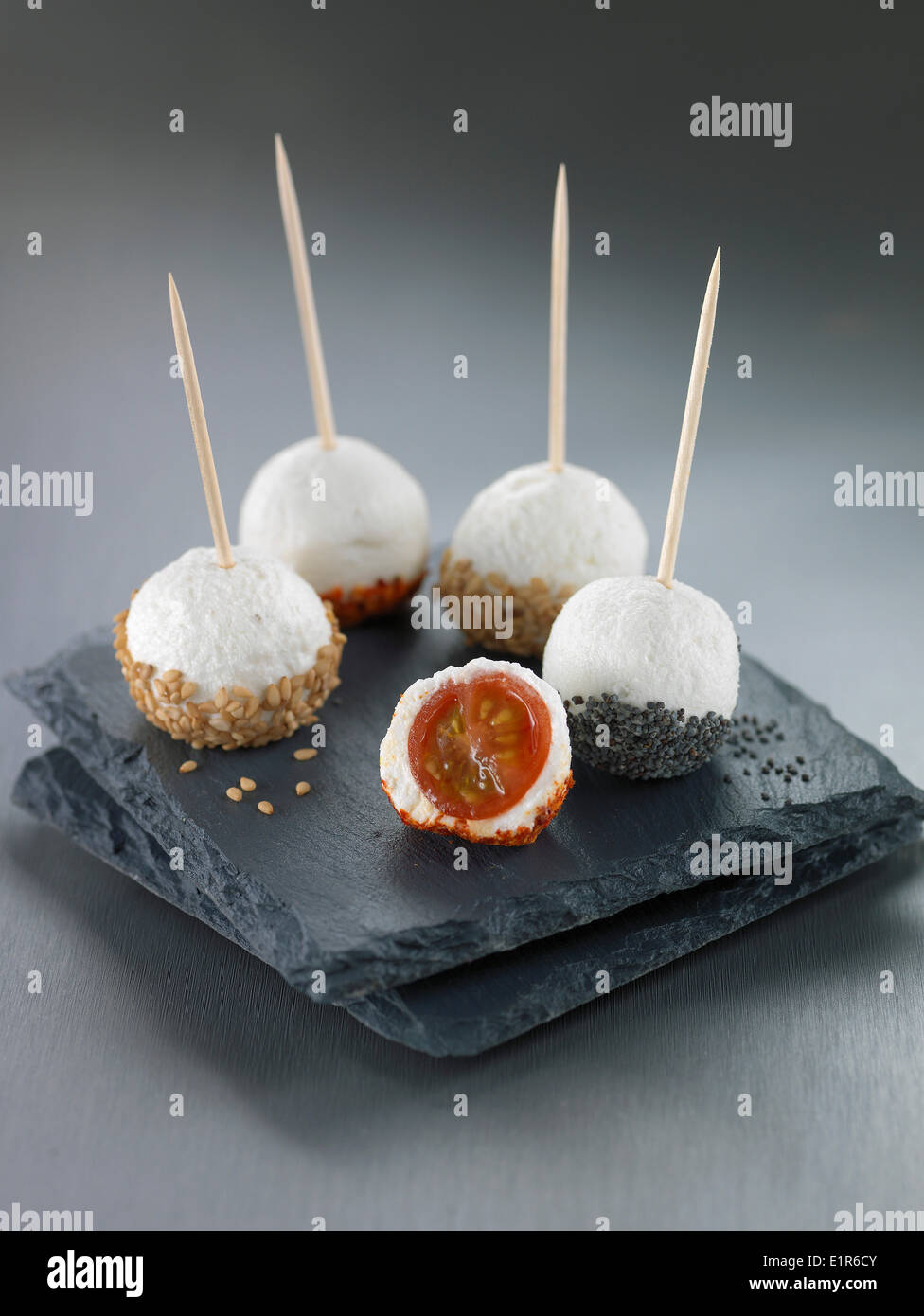 Cherry tomato and cheese balls coated with sesame seeds or poppy seeds Stock Photo