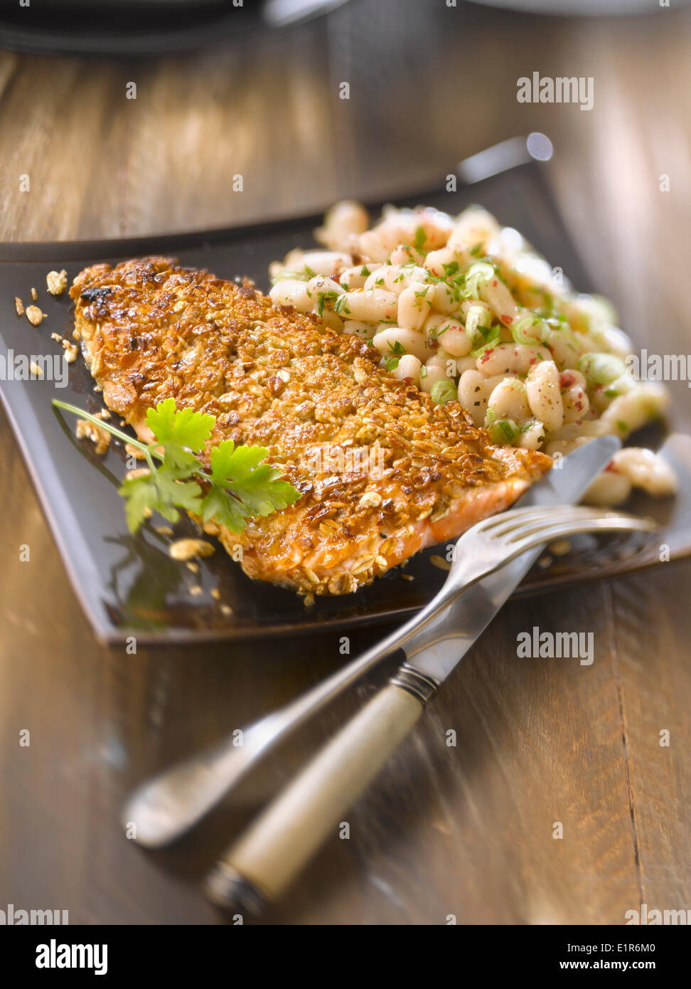 Trout fillet in cereal crust,white bean salad Stock Photo