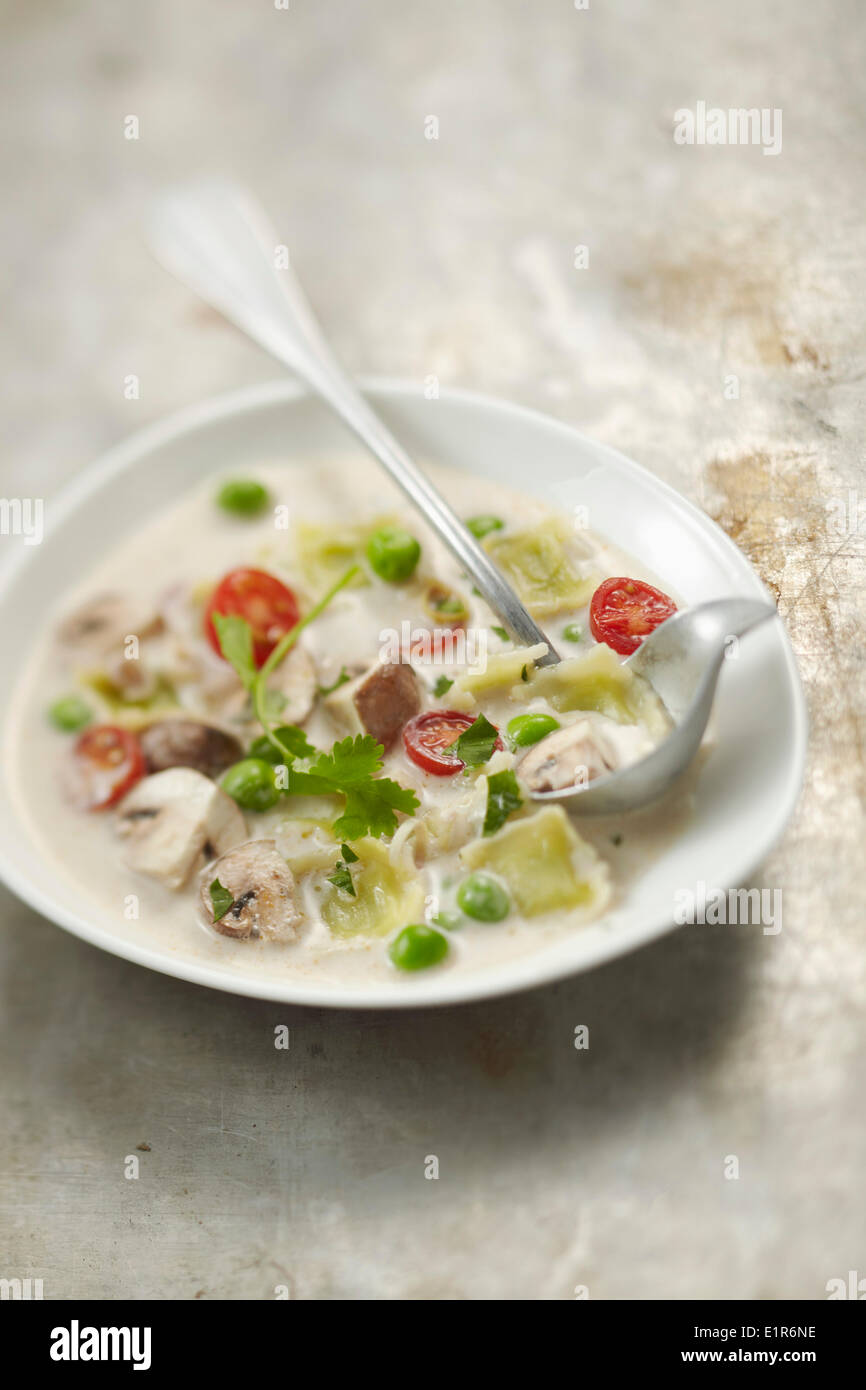 Ravioles de Romans with peas,mushrooms and cherry tomatoes Stock Photo