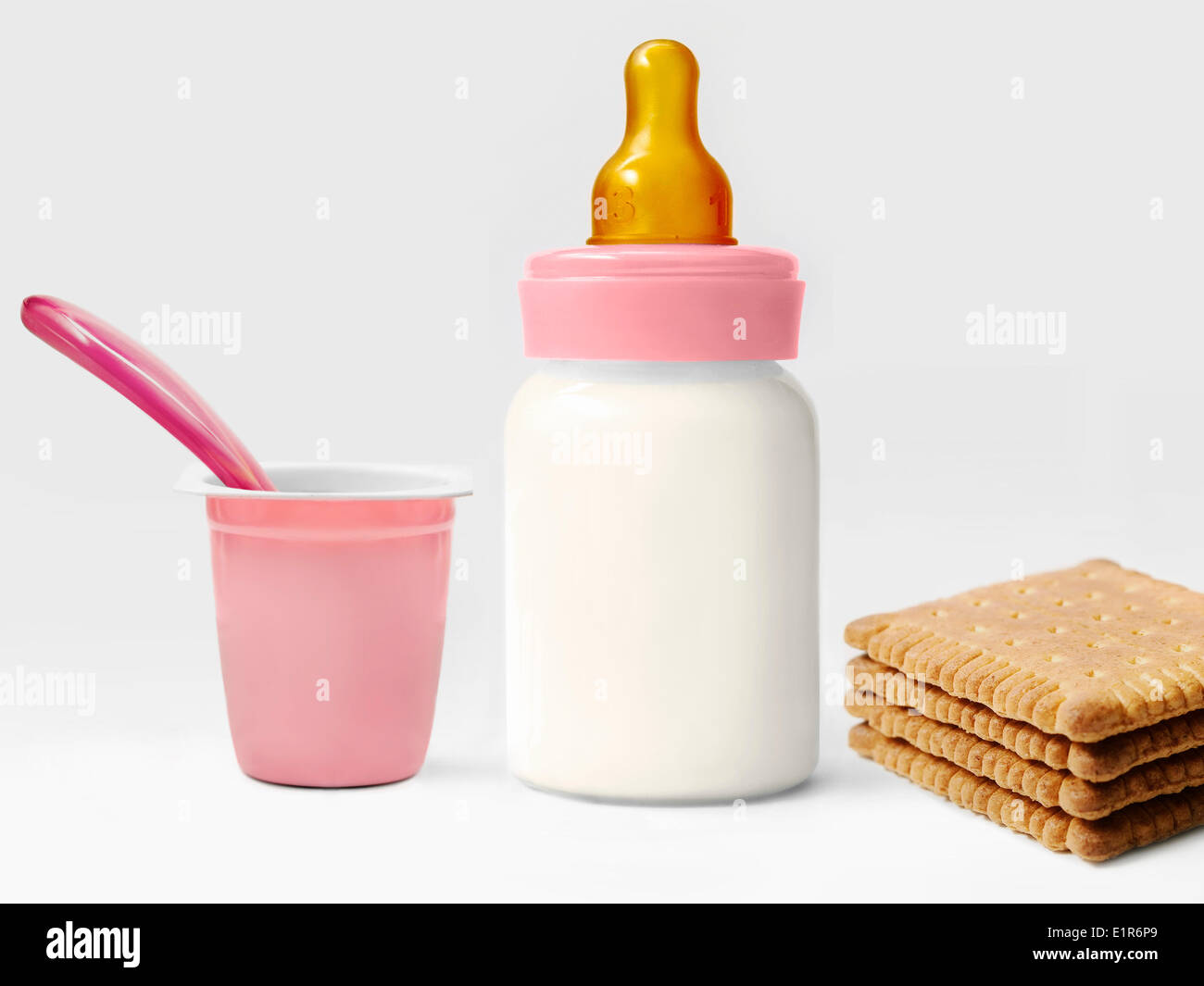 Baby's bottle of milk and an empty yoghurt pot and rich tea biscuits Stock  Photo - Alamy