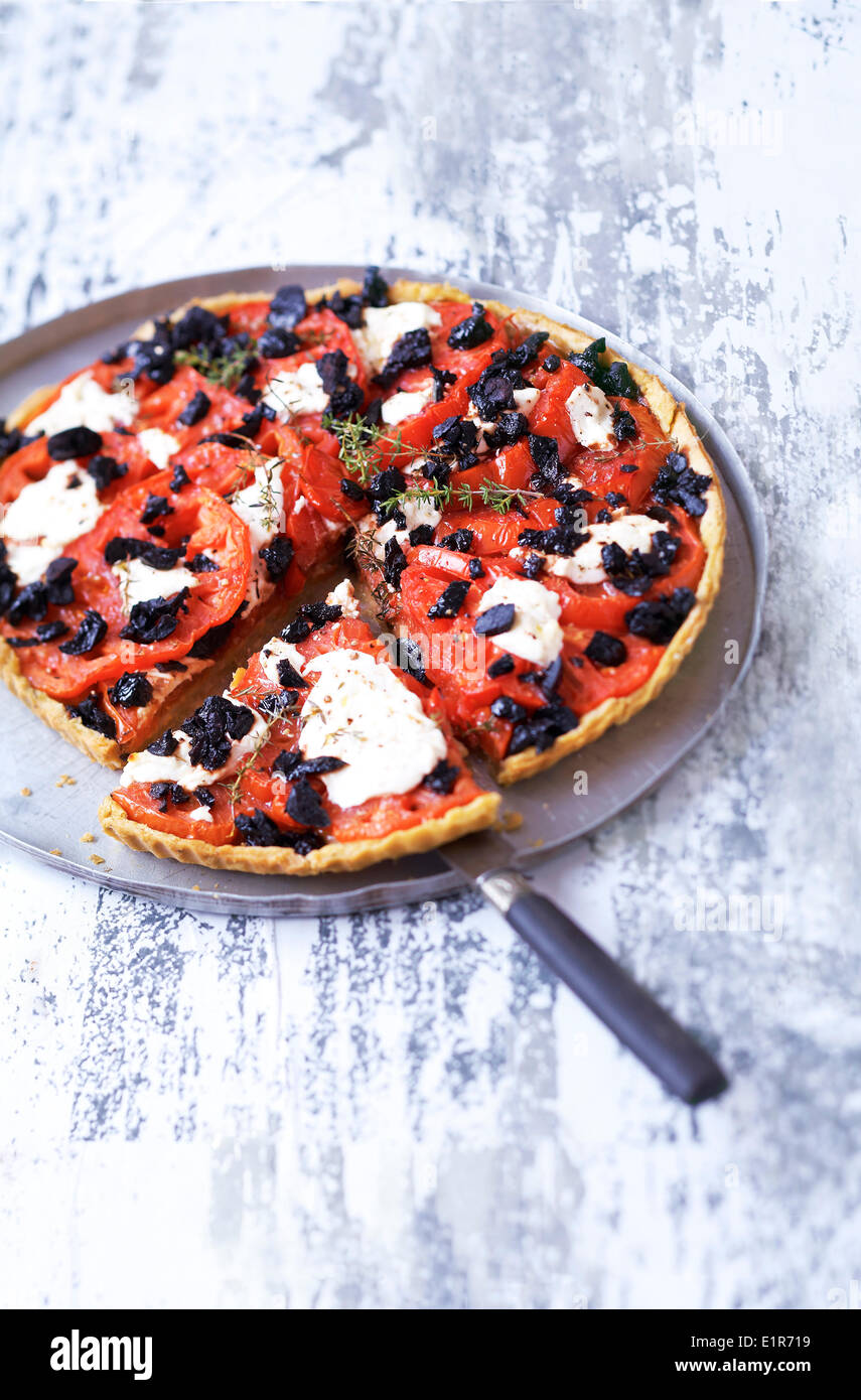 Tomato,black olive and fresh goat's cheese tart Stock Photo