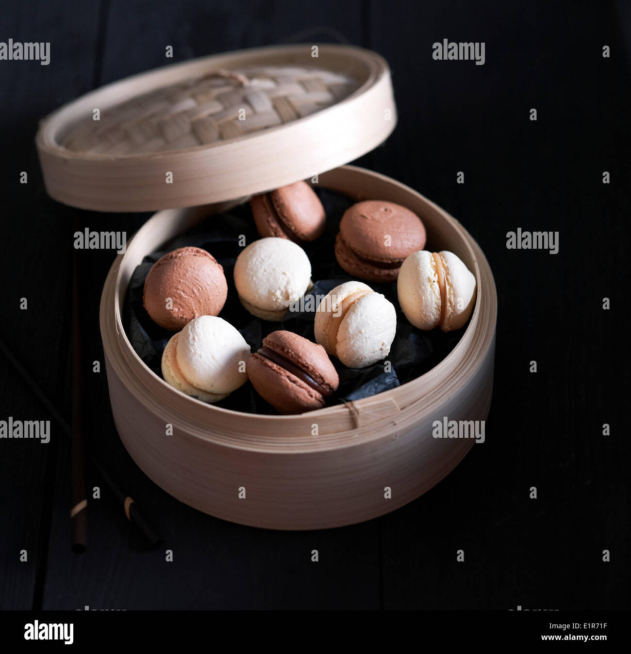 Assorted macaroons in a bamboo basket Stock Photo