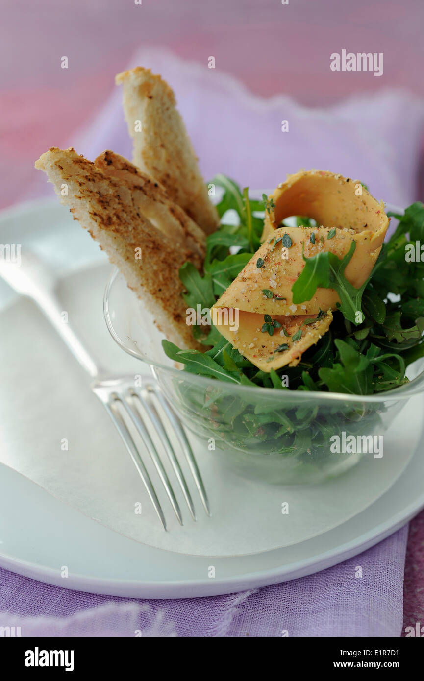 Rocket lettuce salad with thinly sliced foie gras with 5 peppers Stock Photo