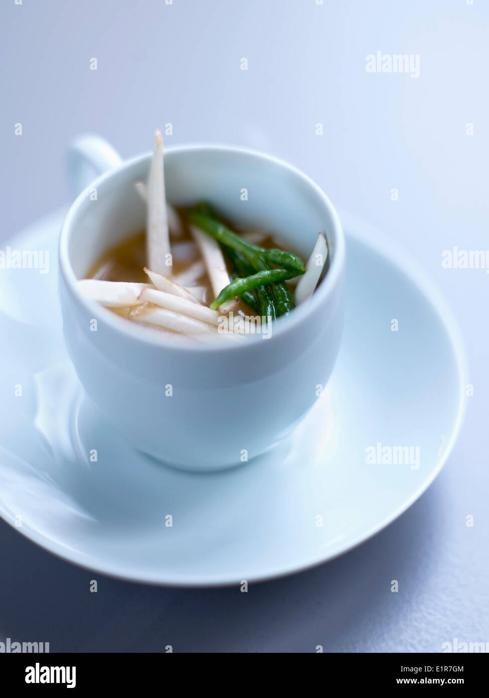 Dublin Bay prawn stock with thinly chopped mushrooms and samphire Stock Photo