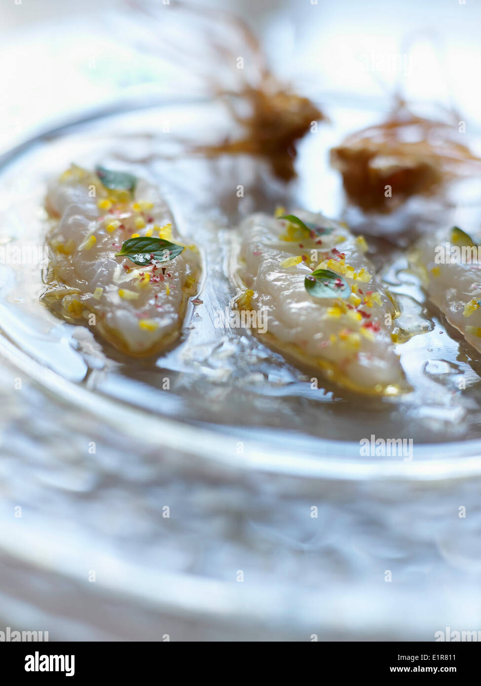 Raw marinated Dublin Bay prawns with ginger and yuzu juice Stock Photo