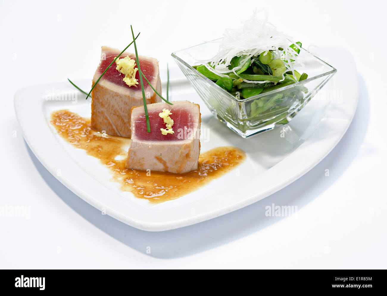 Half-cooked tuna,steamed green vegetables with daikon,ginger vinaigrette Stock Photo