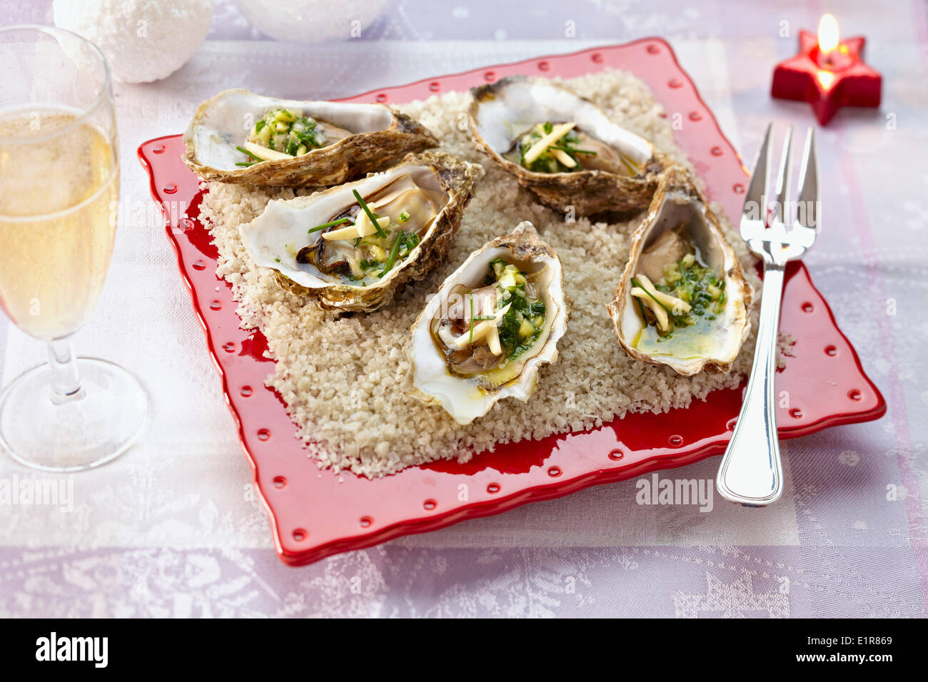Hot oysters with fresh herbs Stock Photo