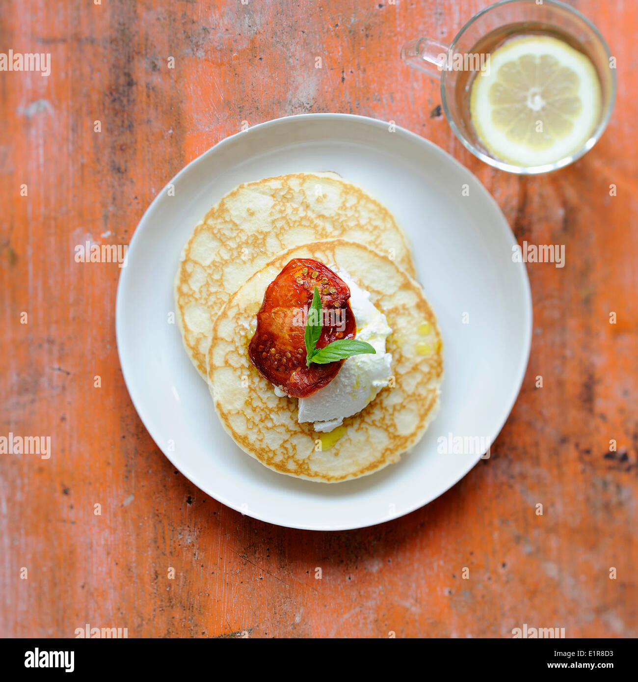 Blinis with ricotta and sun-dried tomatoes Stock Photo