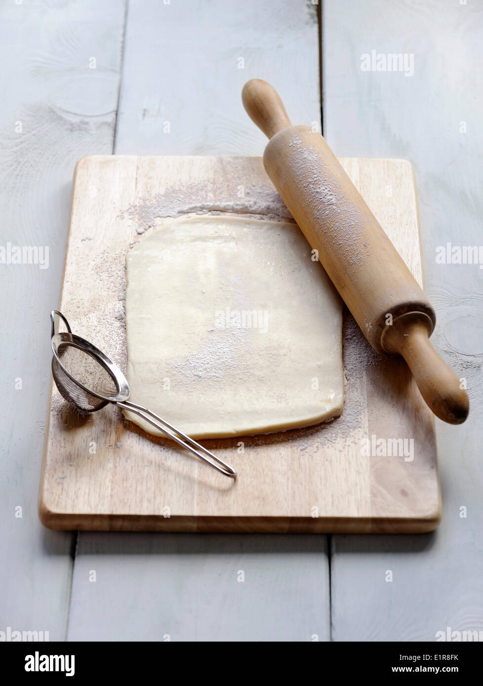Spread the dough with a rolling pin Stock Photo