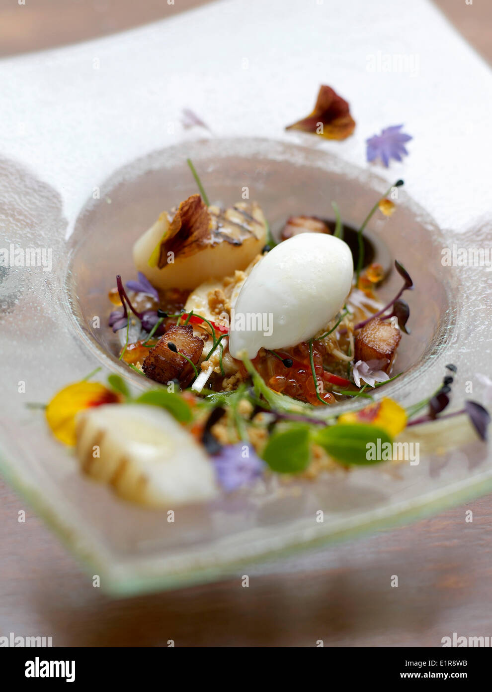 Grilled scallop,sauteed diced potato,sprout and edible flower salad Stock Photo