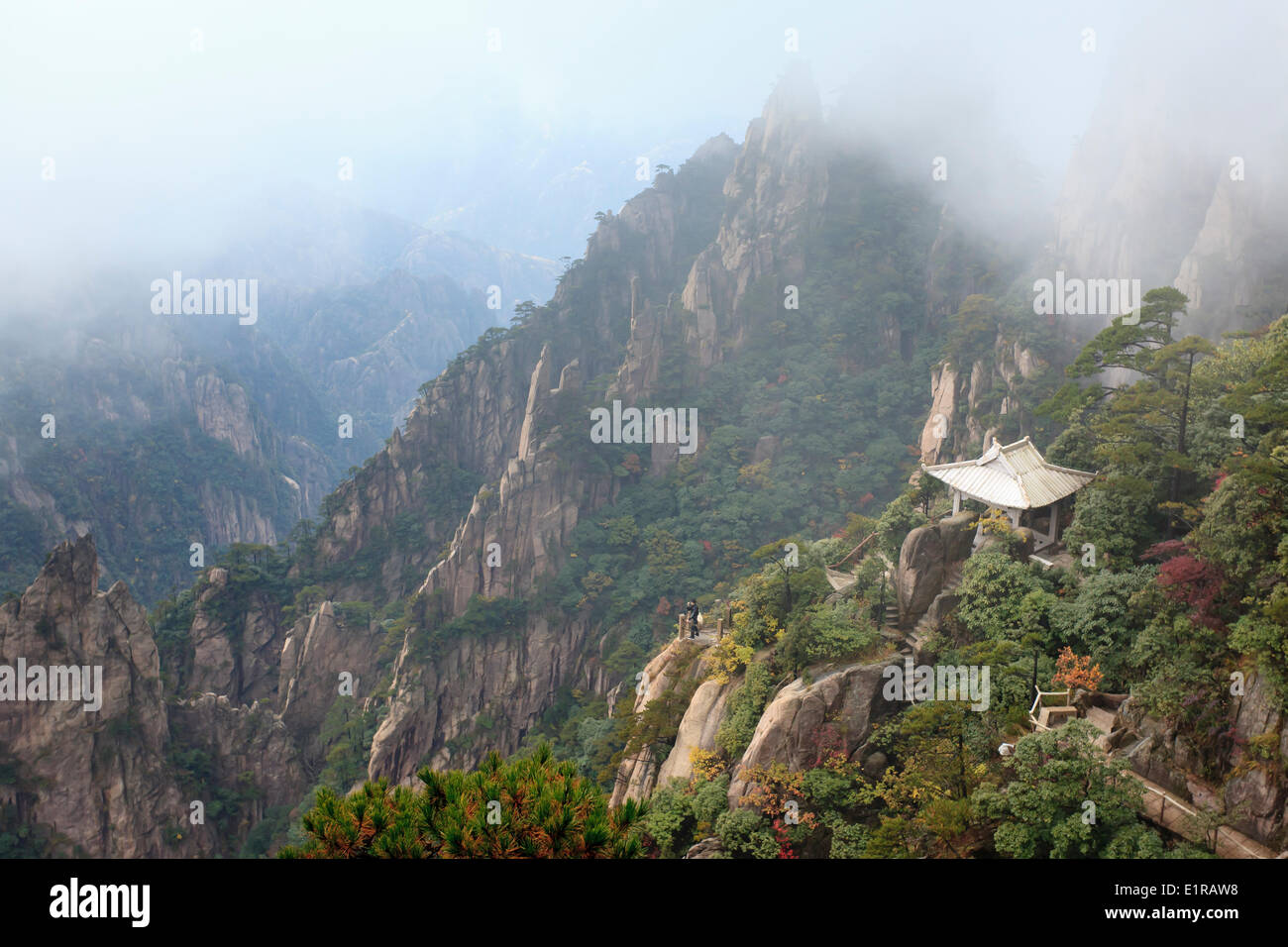 Pagoda and photographer in the foggy yellow Mountains. Stock Photo