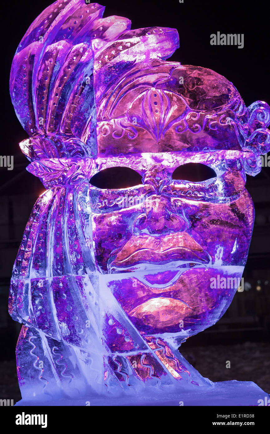 Ice sculpture in Ski resort Bad Gastein, Austria. Photo of woman statue made from ice and lightened with different colored lamps Stock Photo
