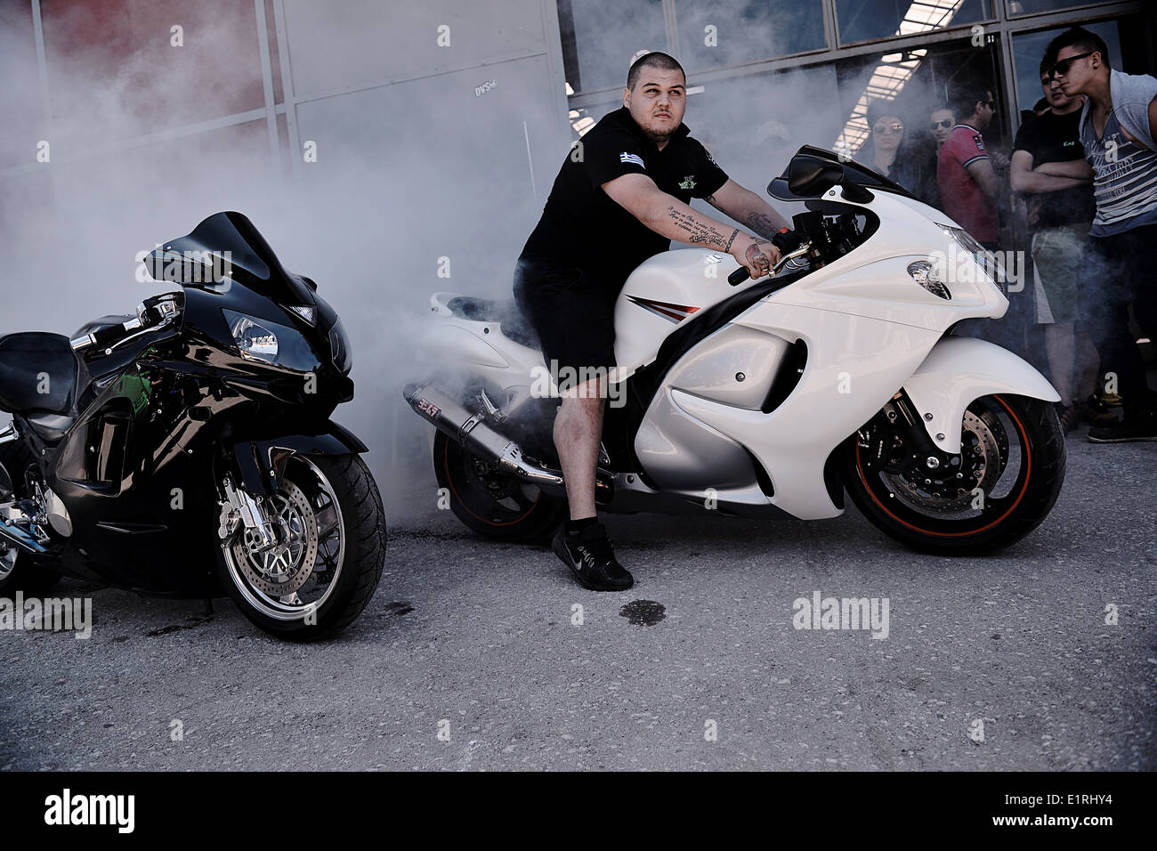 A motorbike driver performs a burnout during a tuning show in Thessaloniki, Greece 2014 Stock Photo