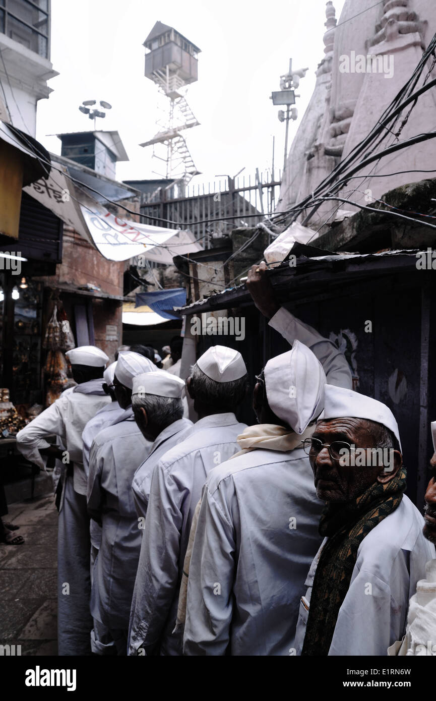 Pilgrims waiting in line, in order to pray in a holy temple in the old city of Varanasi, India 2012 Stock Photo