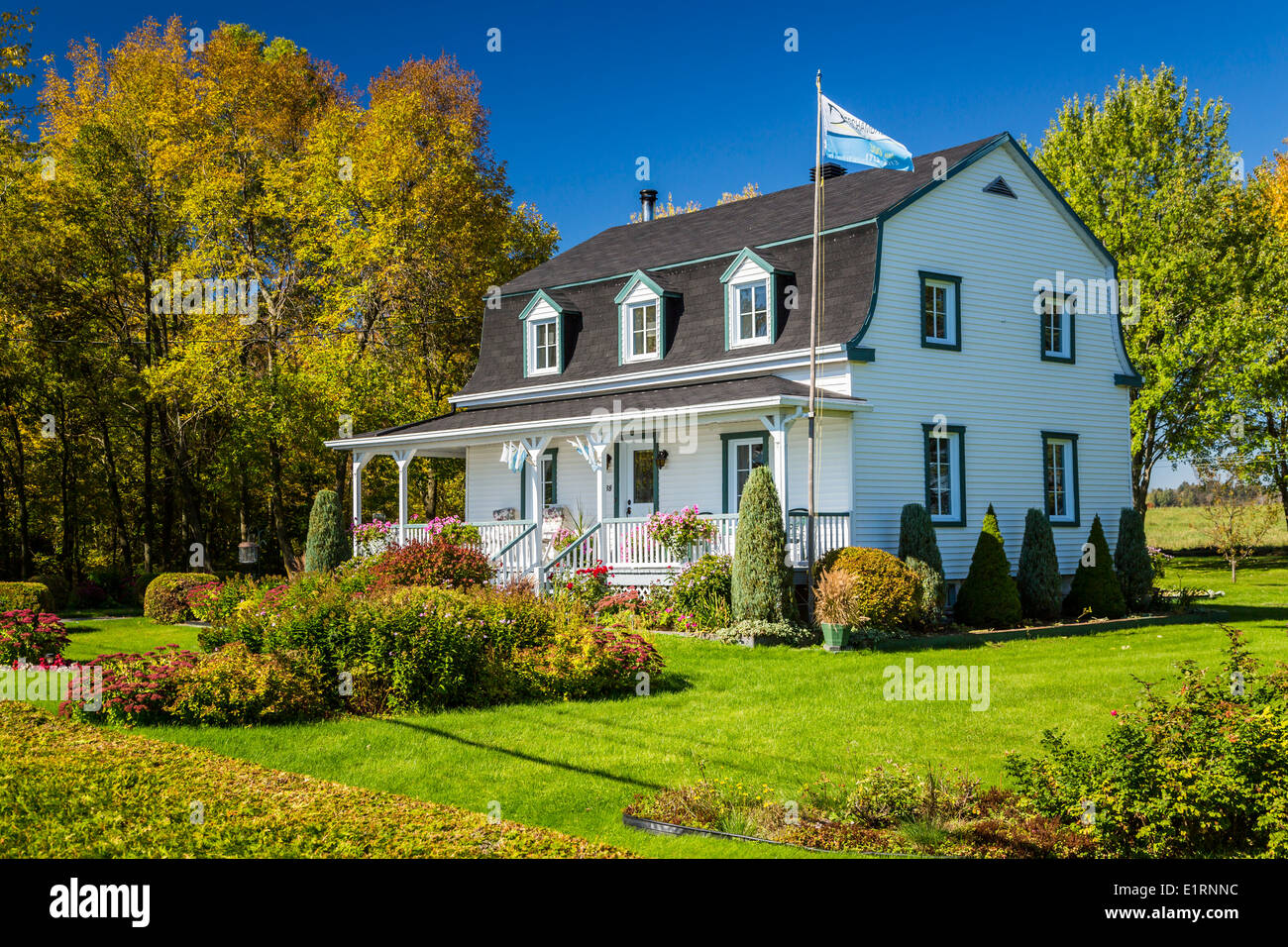 A rural Quebec home in the countryside with fall foliage color, Quebec, Canada. Stock Photo