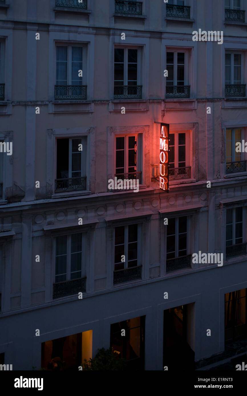Neon sign outside the Amour Hotel at 8 rue Navarin, 9th Arrondissement, Paris, France. Stock Photo