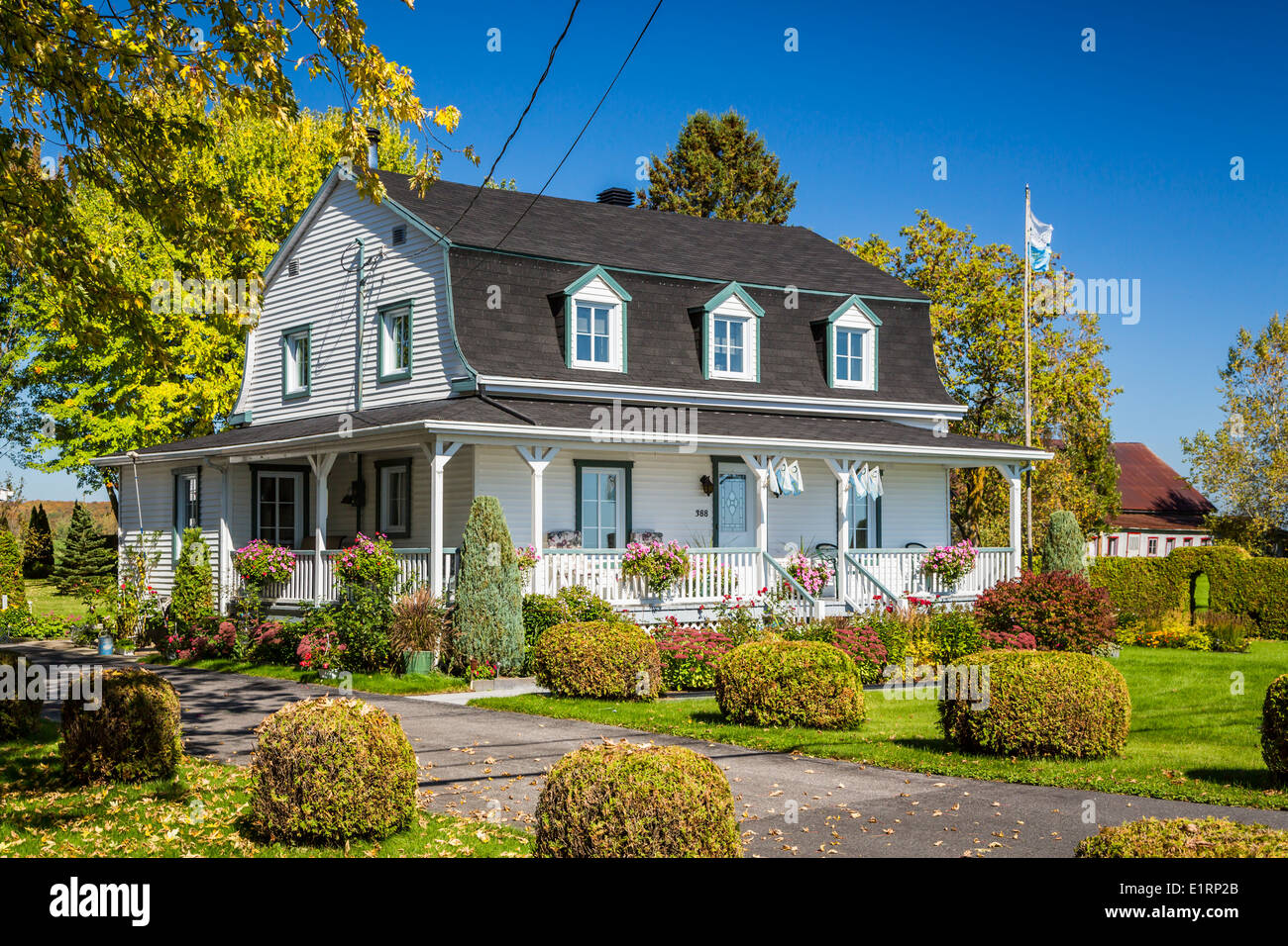A rural Quebec home in the countryside with fall foliage color Stock