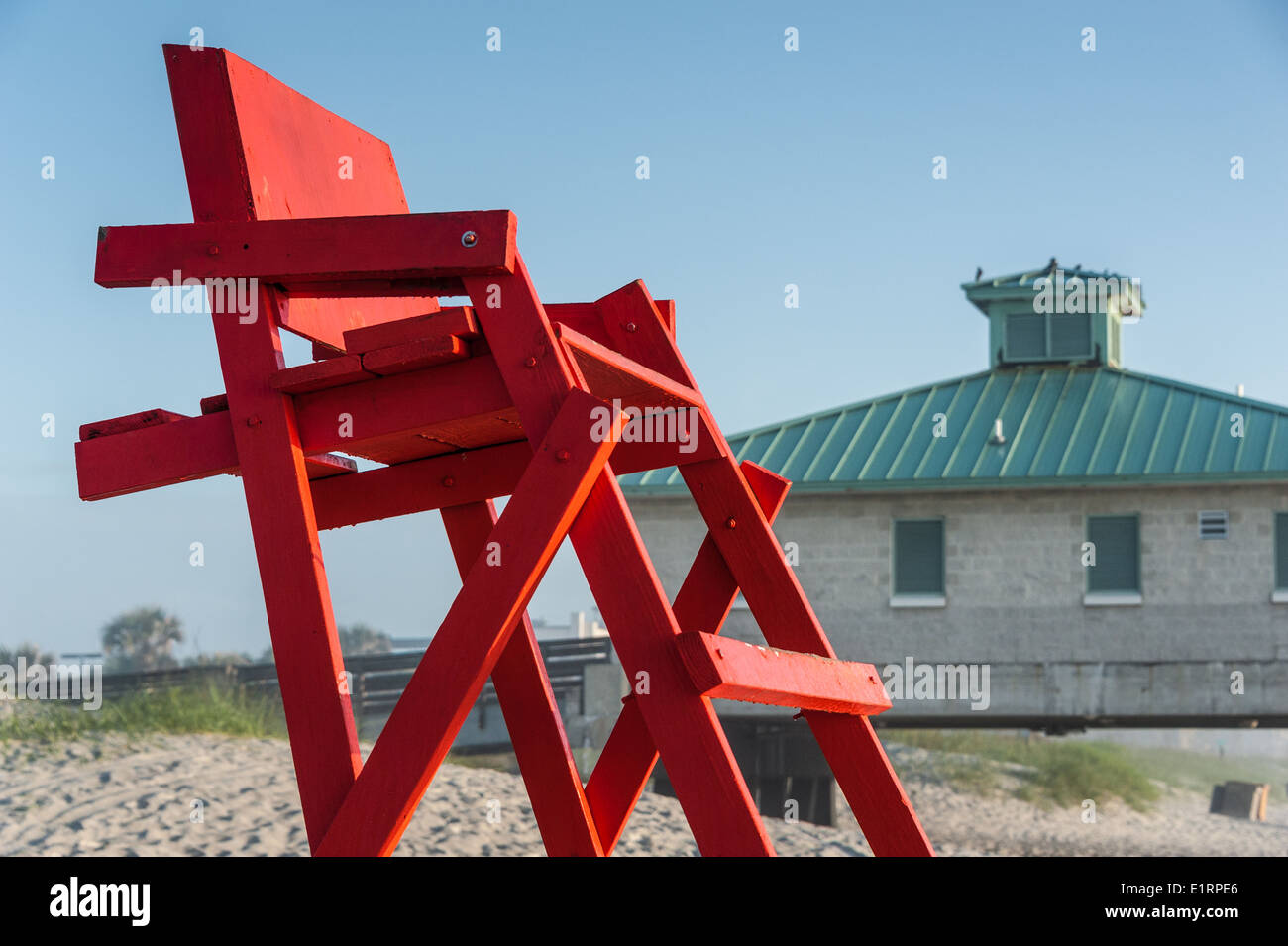 The rising sun lights a bright red lifeguard stand on a beautiful morning at Jacksonville Beach, Florida. (USA) Stock Photo