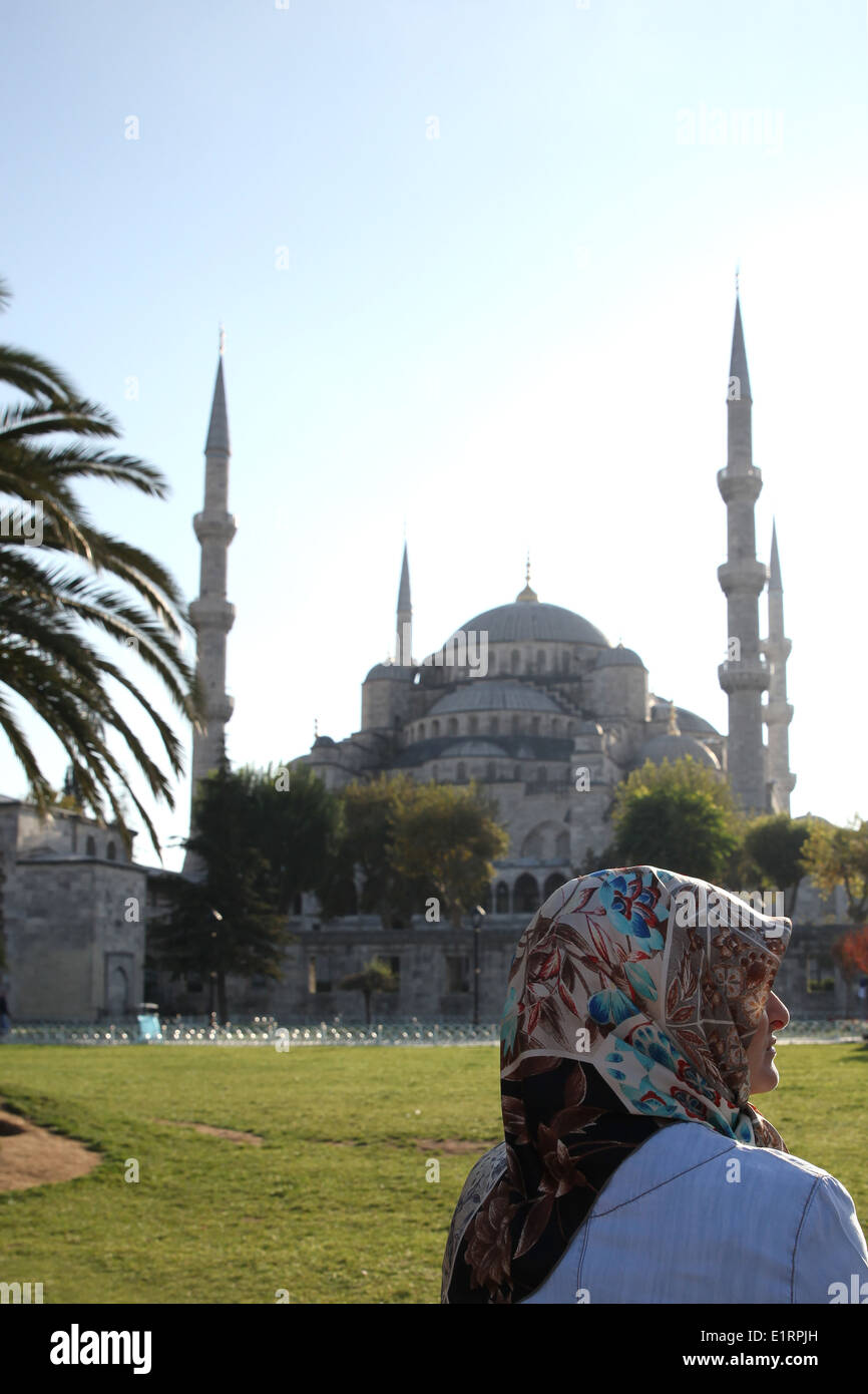 Muslim woman in front of the Sultan Ahmed Mosque, also called the blue mosque, in Istanbul, Turkey Stock Photo