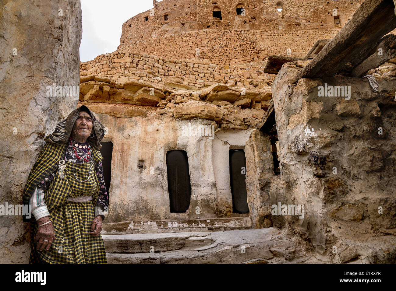 A Berber woman in front of her traditional house Stock Photo