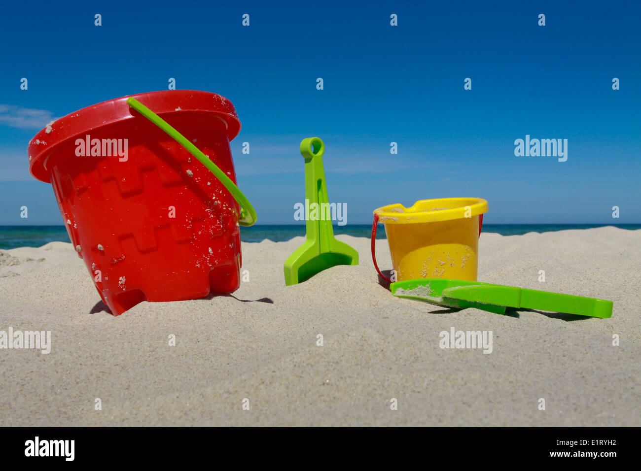 Plastic buckets and shovels on sandy beach at Baltic sea Stock Photo