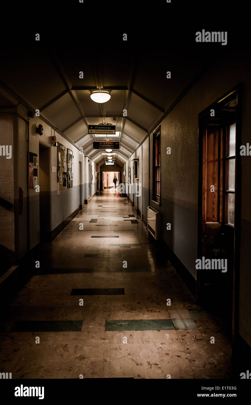 Corridors of Whitchurch Hospital Cardiff. Dimly lit by small amount of lights and window light. Stock Photo