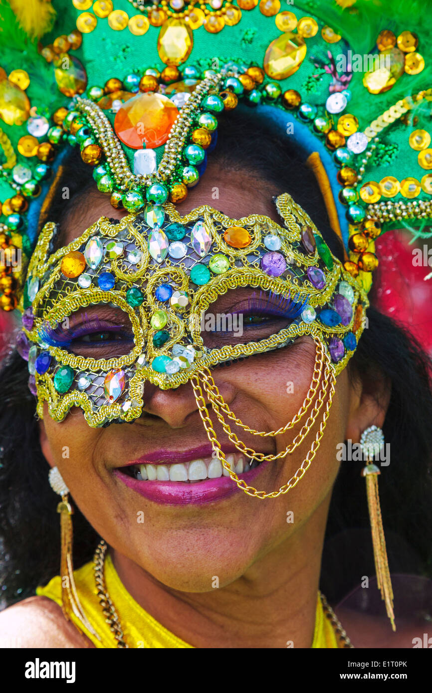 Woman dressed in traditional Brazil face mask, on parade at the West End Festival and Mardi gras, Glasgow, Scotland, UK Stock Photo