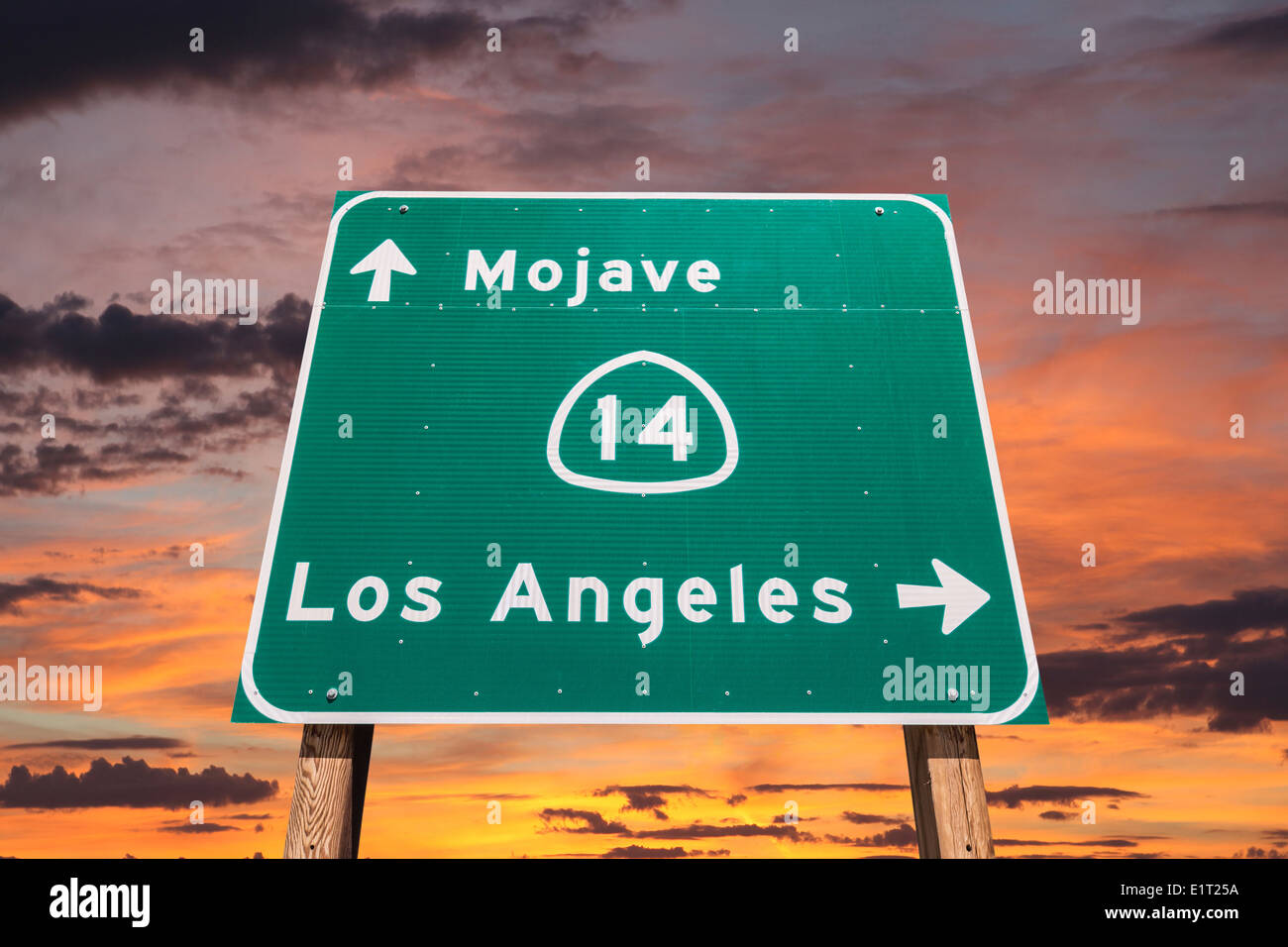 Mojave desert freeway sign towards Los Angeles with sunset sly. Stock Photo