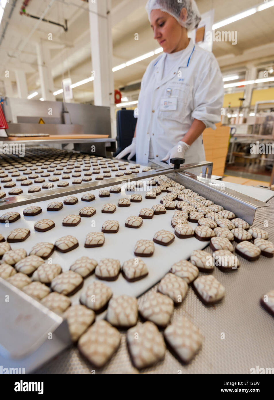 Workers at the Swiss chocolate factory of Lindt & Spruengli in Zurich / Kilchberg are producing chocolate candies. Stock Photo