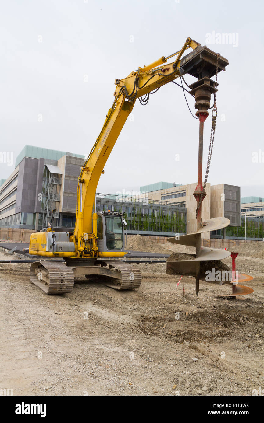Drilling excavator with auger spiral attachment seen in Denmark Stock