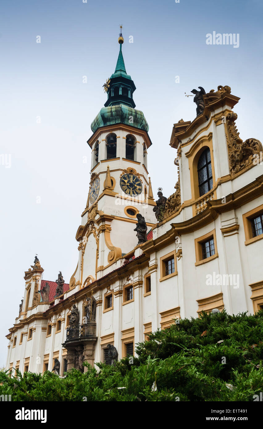 Loreta Sanctuary in Prague, with the Saints statues on the main entrance and with baroque bell tower Stock Photo
