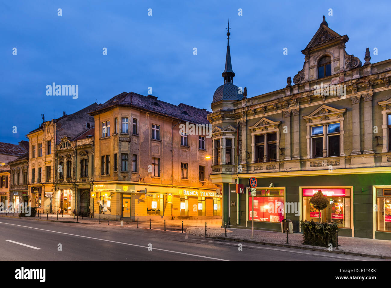Image with medieval downtown street at twilight. Brasov is a historical saxon city of Transylvania in Romania. Stock Photo