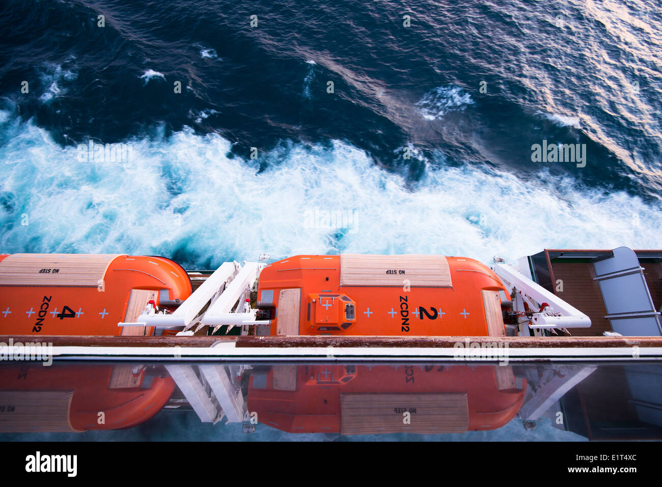 View down onto lifeboats of MV Arcadia in the early evening light whilst she sails in the North Sea Stock Photo