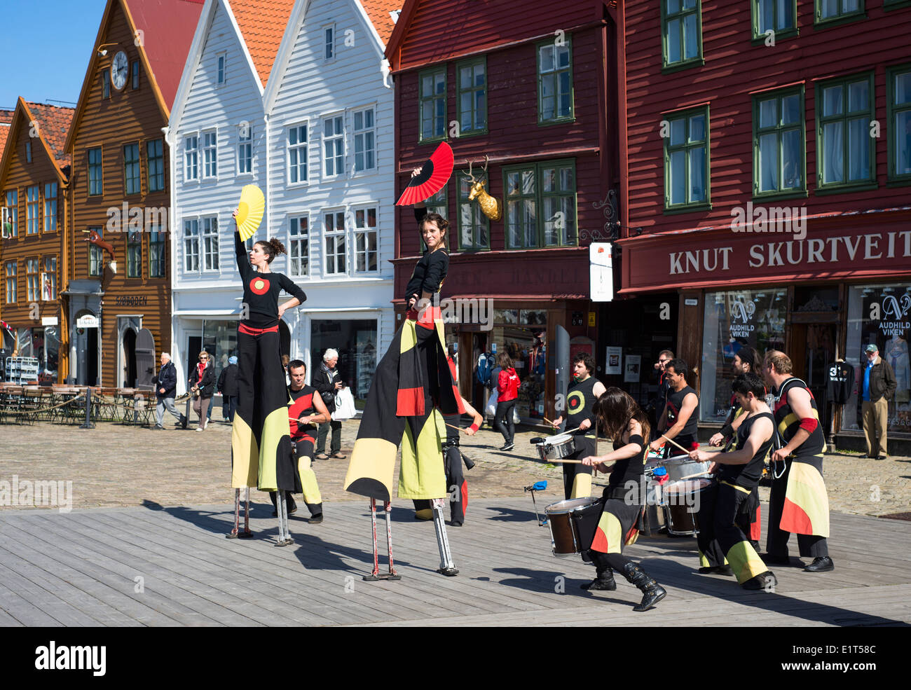 Street performers by the old wharfside buildings of Bryggen, in Bergen, Norway Stock Photo