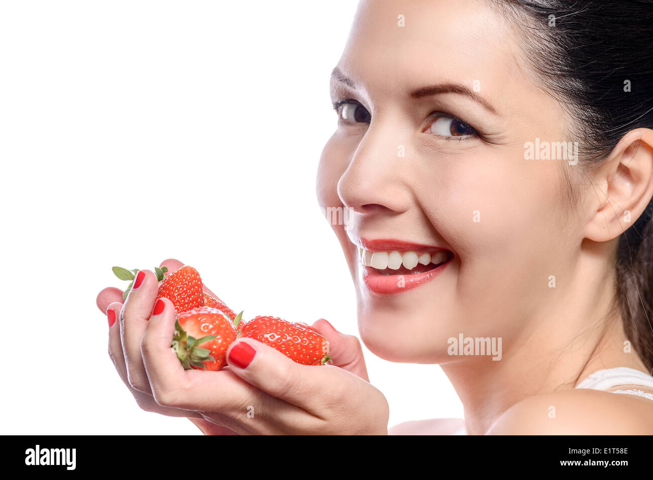 Smiling Woman with Strawberries in her Hand Stock Photo