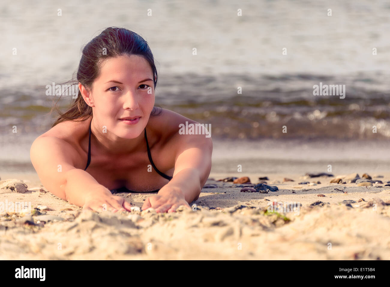 Beautiful woman laying on beach hi-res stock photography and images pic