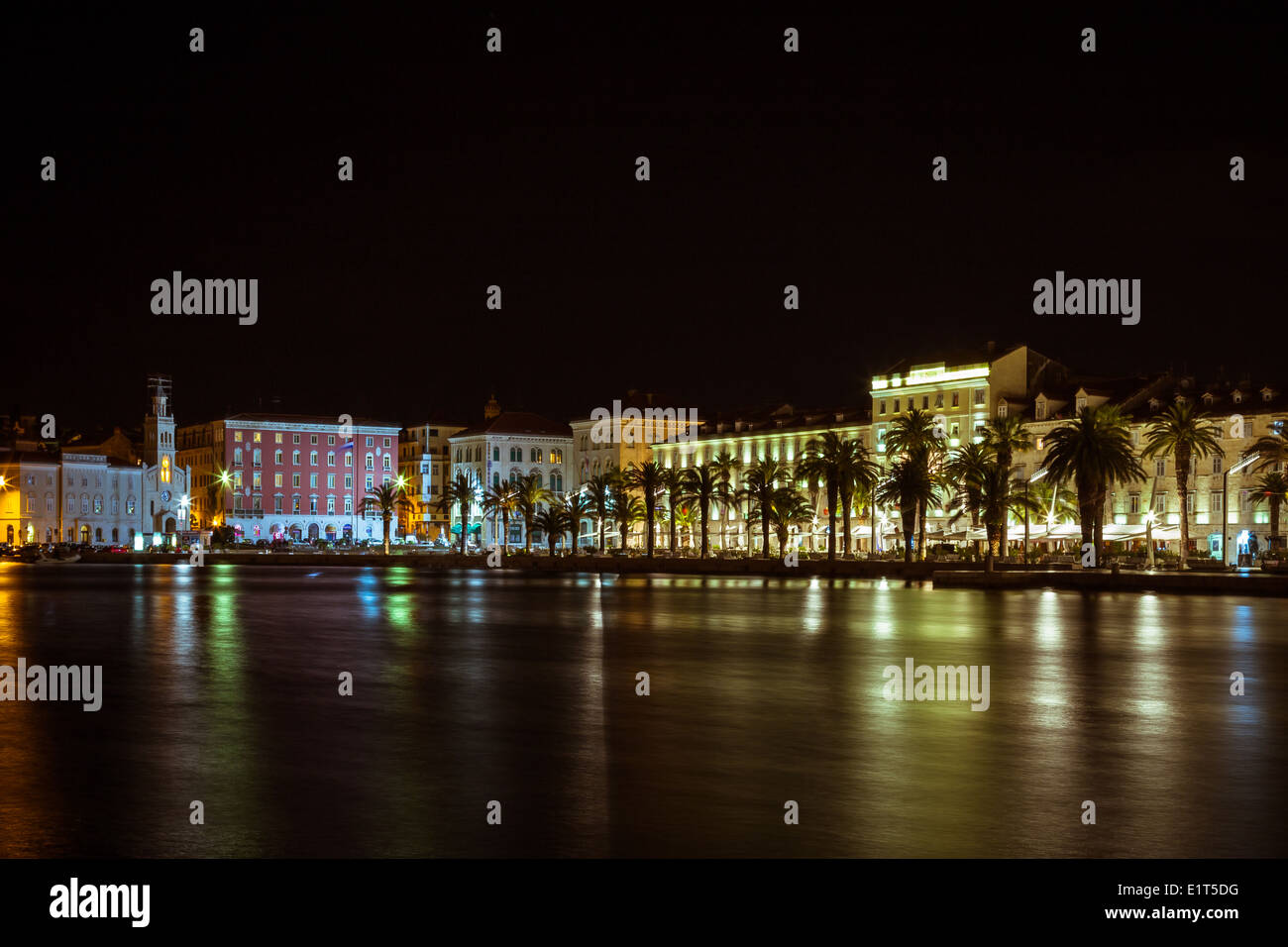 Night-time at Split riva, Croatia. lights from the Franciscan church & monastery of St Stephen reflect in the water Stock Photo