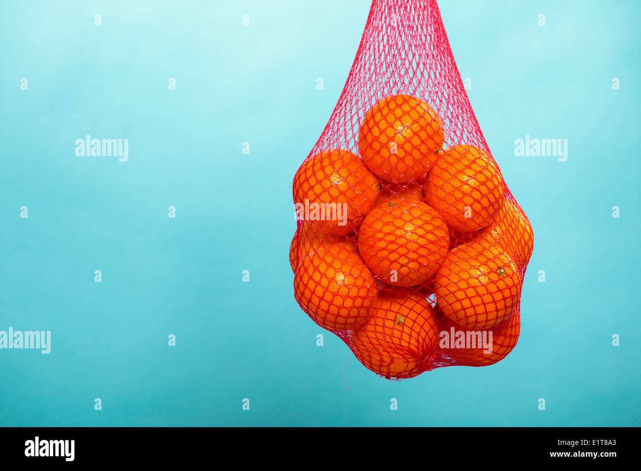 Woman with reusable string bag of tangerines in garden - a Royalty Free  Stock Photo from Photocase
