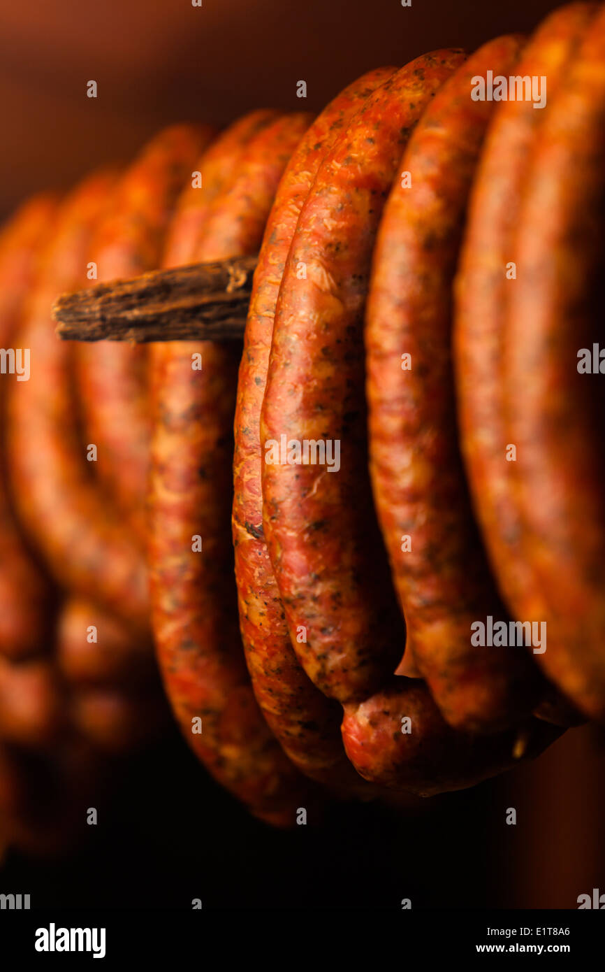 Traditional food. Smoked sausages meat hanging in domestic smokehouse