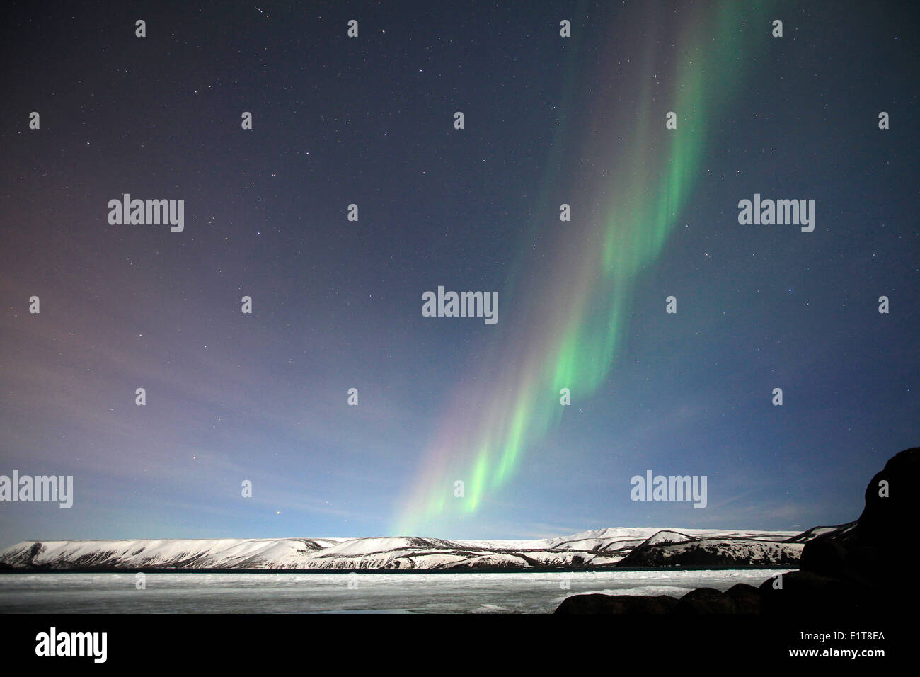 The Northern Lights shine above a frozen lake outside Reykjavik in ...
