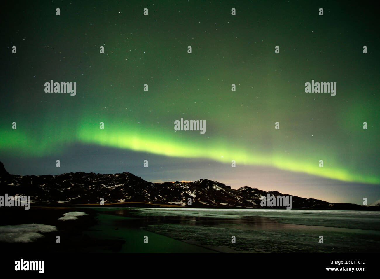 The Northern Lights shine above a frozen lake outside Reykjavik in ...