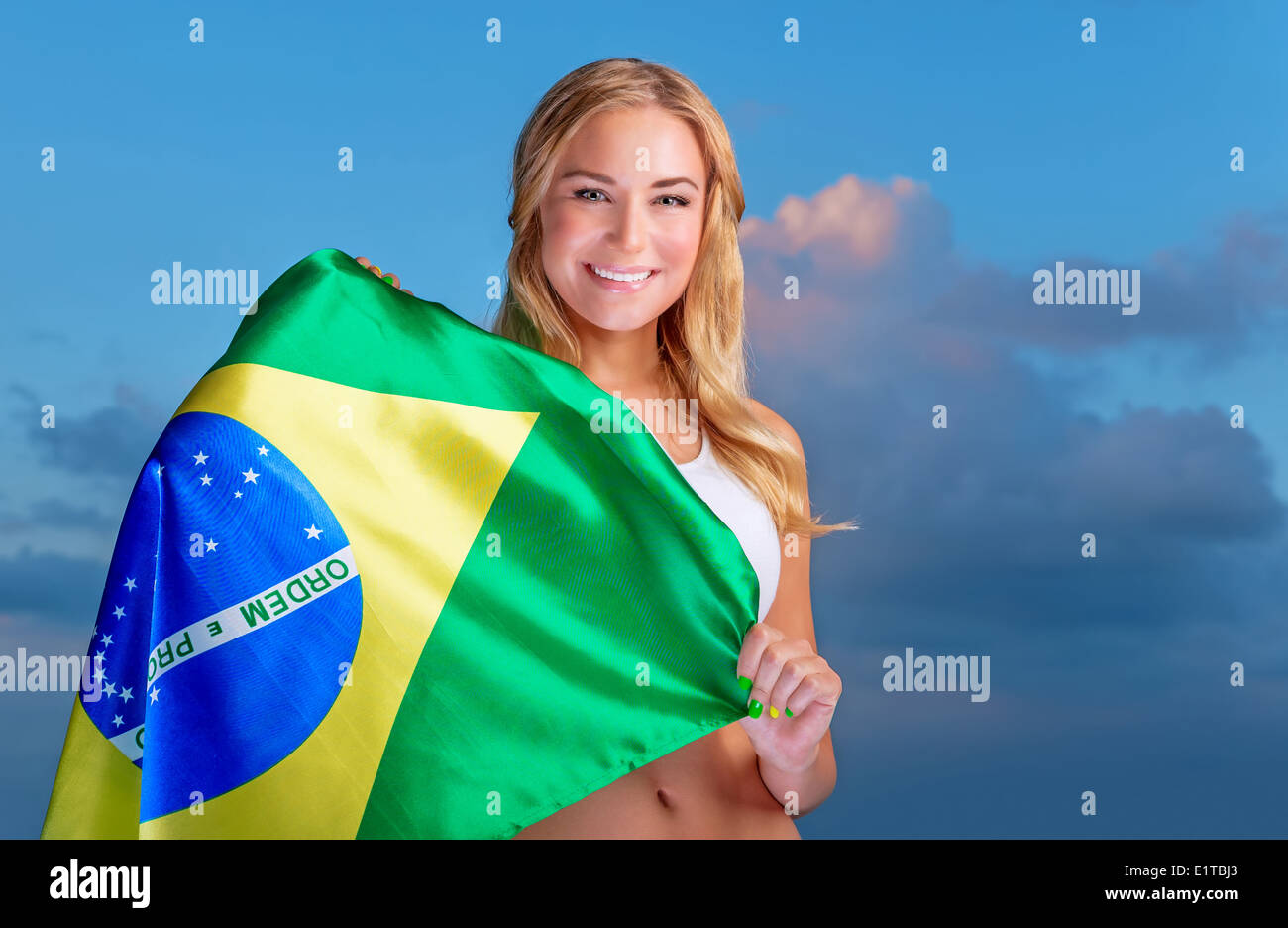 Happy fan of Brazilian football team, cheerful pretty girl on stadium