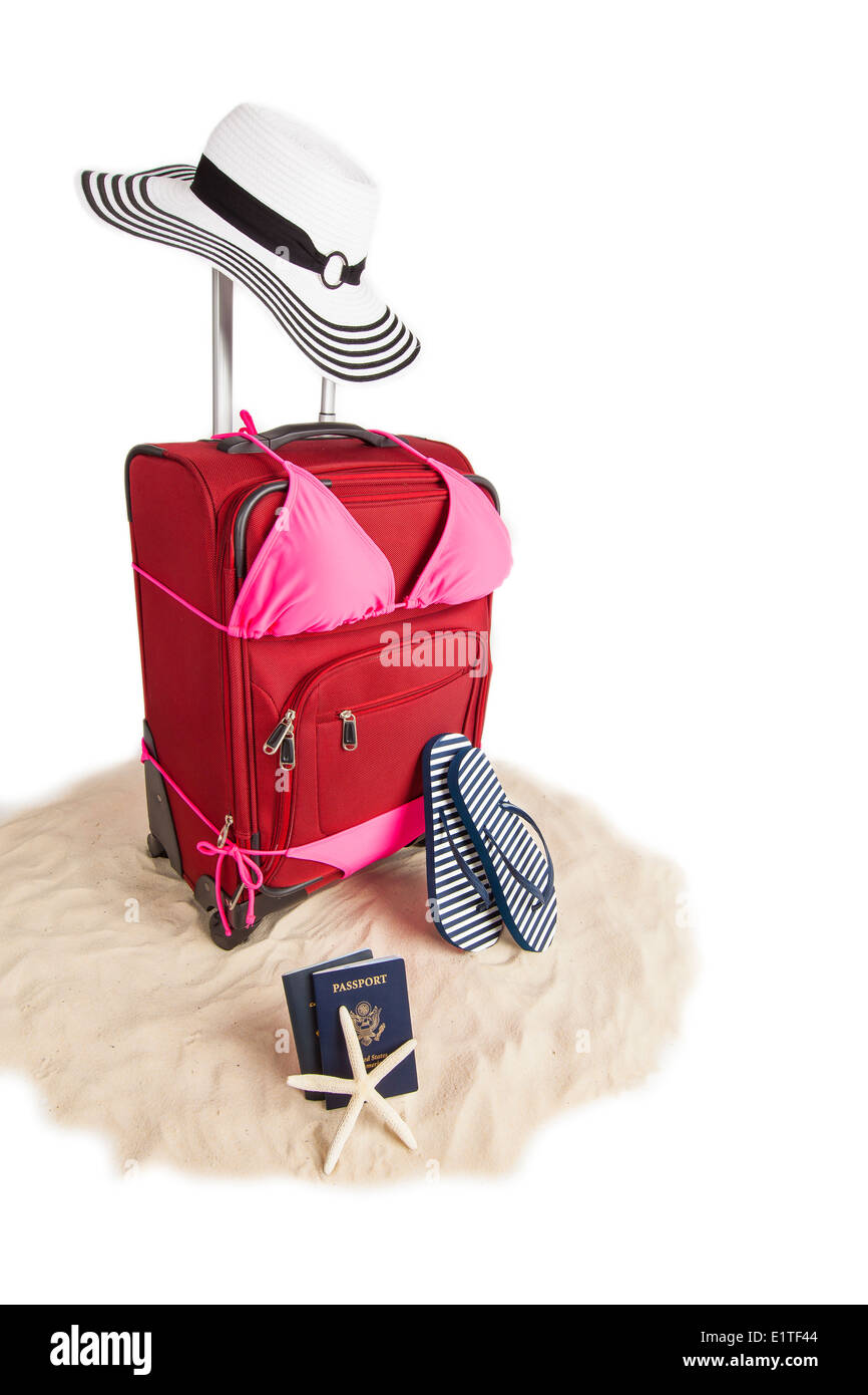 Picture of Red Suitcase Ready for Travel To Beach Vacation With Sandals, Sand, Beach Hat, Star Fish, Passport and Flip Flops Stock Photo