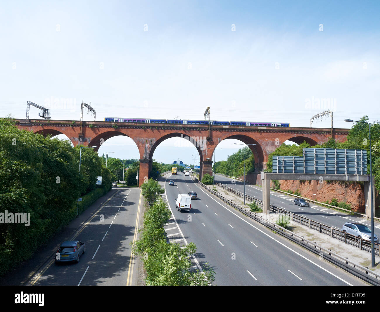 Stockport viaduct over the M60 Motorway with passing train in Stockport Cheshire UK Stock Photo