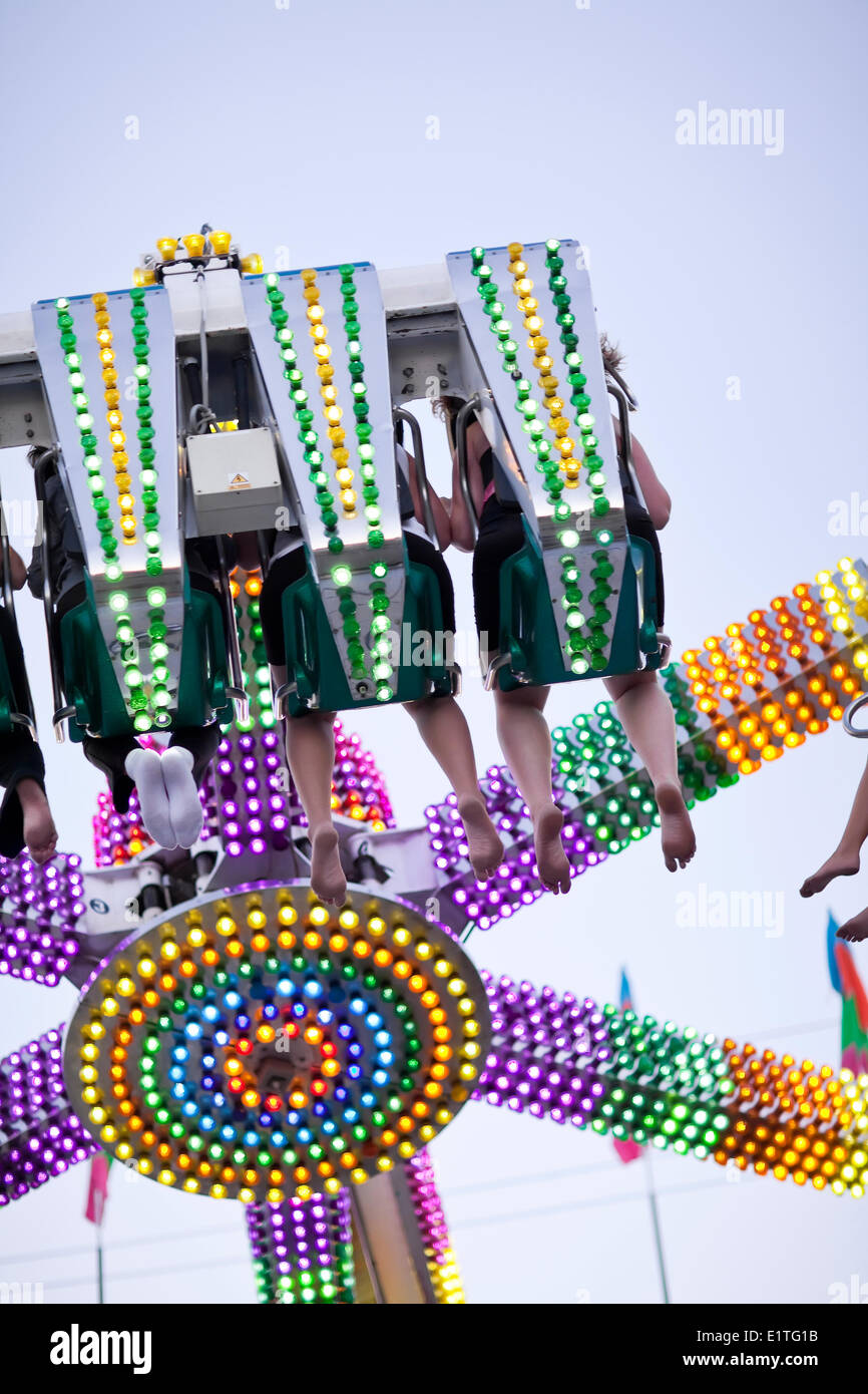 People on an amusement park ride at the Morden Corn and Apple Festival, Morden, Manitoba, Canada Stock Photo
