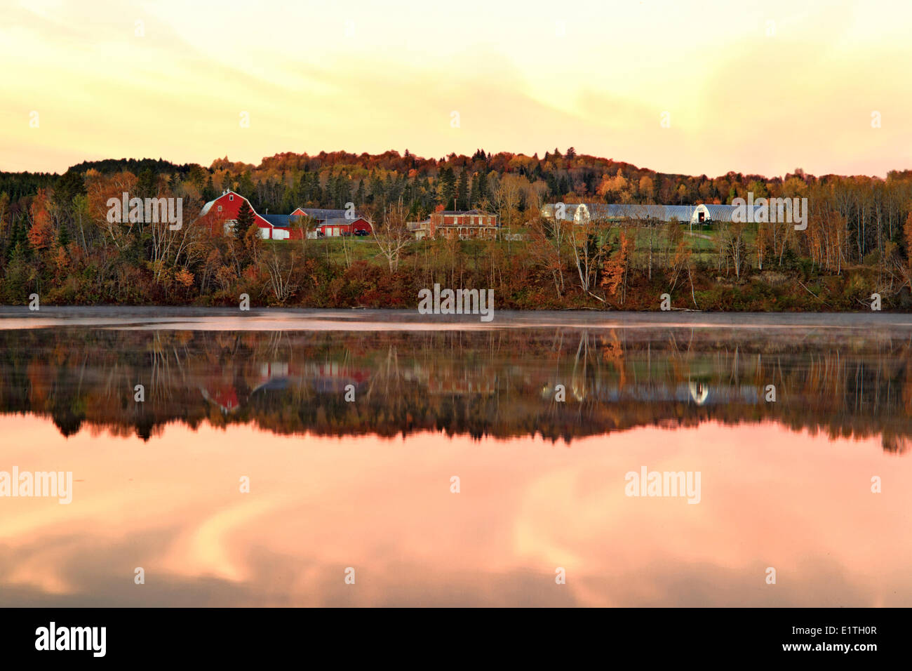 Farm at dusk on the Saint John River, Saint-Léonard, New Brunswick, Canada Stock Photo