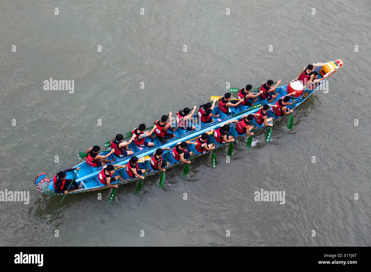 A competing team paddles to the starting line at the annual Dragon Boat Festival in Taipei, Taiwan, Saturday, May 31, 2014. Dragon boat races are held across Southeast Asia for more than 2000 years to remember Chu Yuan, an ancient Chinese poet and ministe Stock Photo