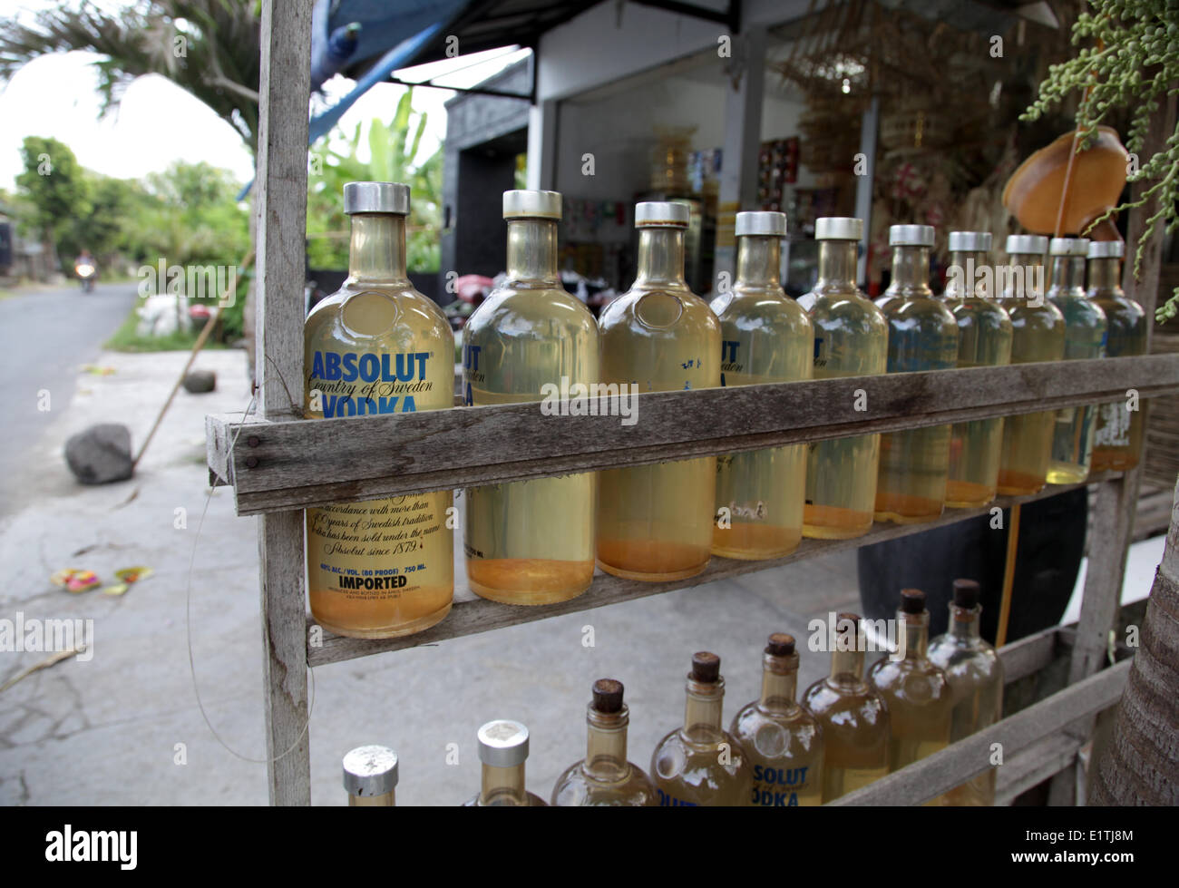 Beside traditional petrol stations in Bali, there is a vast number of roadside stands with the petrol typically stored in Absolut Vodka bottles. Most of the petrol is sold to motor-bikers. Bali, Indonesia, May 1, 2014. (CTK Photo/Karel Picha) Stock Photo