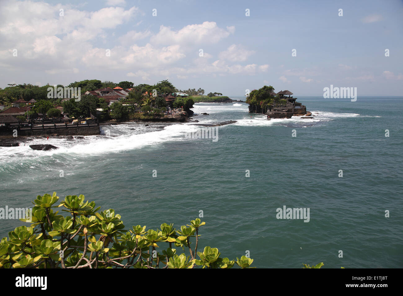 The Tanah Lot sea temple was built on top of a huge rock surrounded by the sea, around five hundred years ago. The temple is one of 7 sea temples in Bali and it's considered as one of the most beautiful spots on the west cost of Bali, Indonesia, May 2, 20 Stock Photo