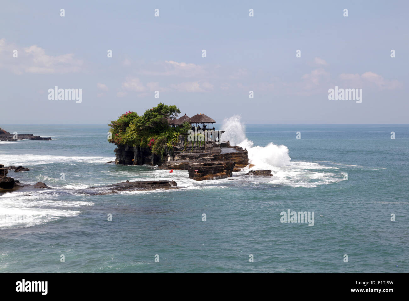 The Tanah Lot sea temple was built on top of a huge rock surrounded by ...